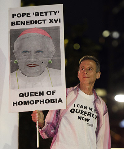 Sydney Mardi Gras: Peter Tatchell stands on a float holding an anti-Pope sign 
