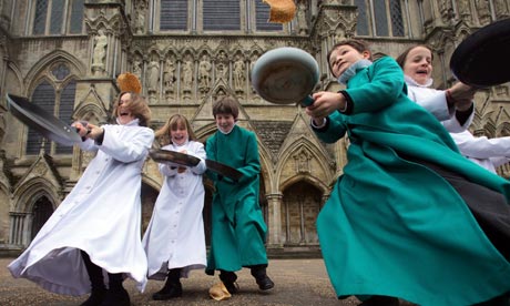 Pancakes are tossed by choristers at Salisbury Cathedral