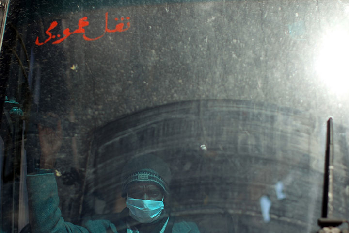 24 hours in pictures: Ras Jdir, Tunisia: A bus takes men to a United Nations displacement camp 