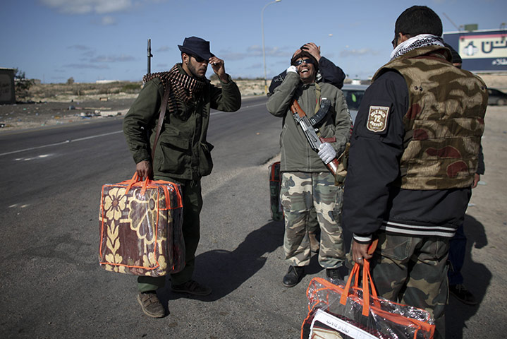 Libya battles continue: Libyan volunteers wait for a ride to a place where they can sleep the night