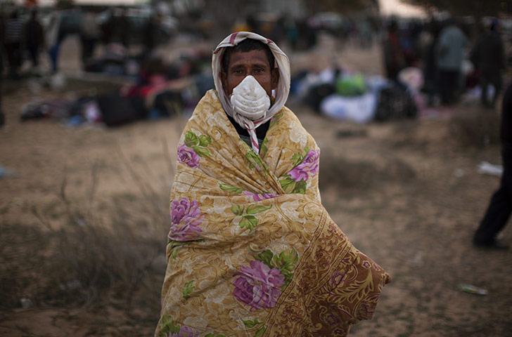 Libya battles continue: Abdul Malek during his repatriation process in a refugee camp 