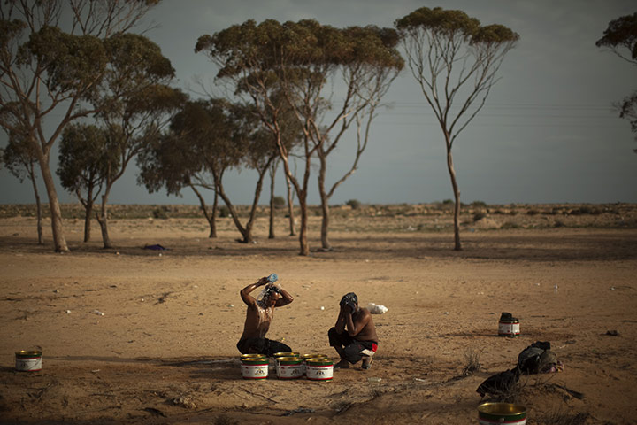 Libya Ras Jdir: Men from Bangladesh wash themselves in a refugee camp in Ras Jdir