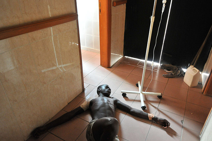 Ivory Coast violence: A wounded man receives medical care at a hospital in Treichville