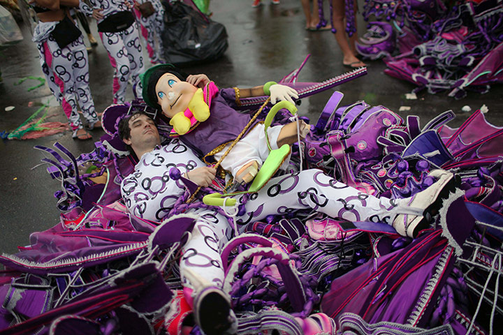 from the agencies : A samba school dancer rests after a carnival parade at the Sambadrome