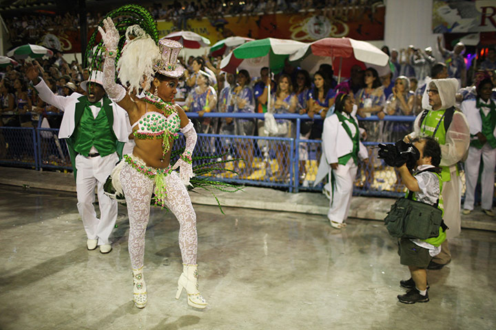 from the agencies : A Mangueira samba school dancer poses for a photographer
