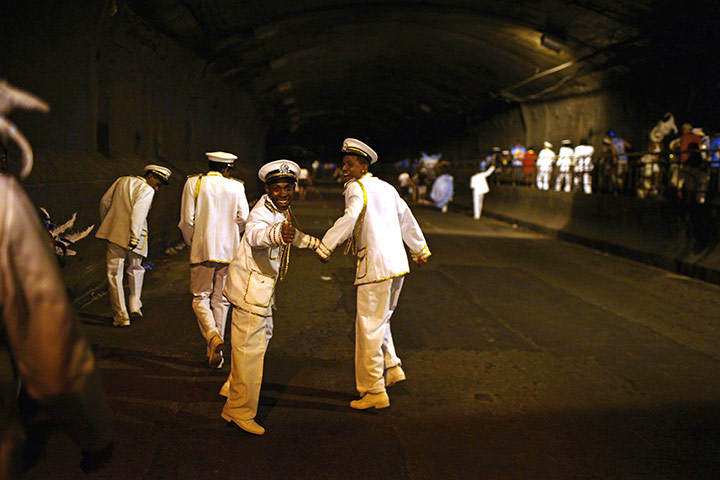 from the agencies : Performers leave the Sambadrome at the end of carnival celebrations 