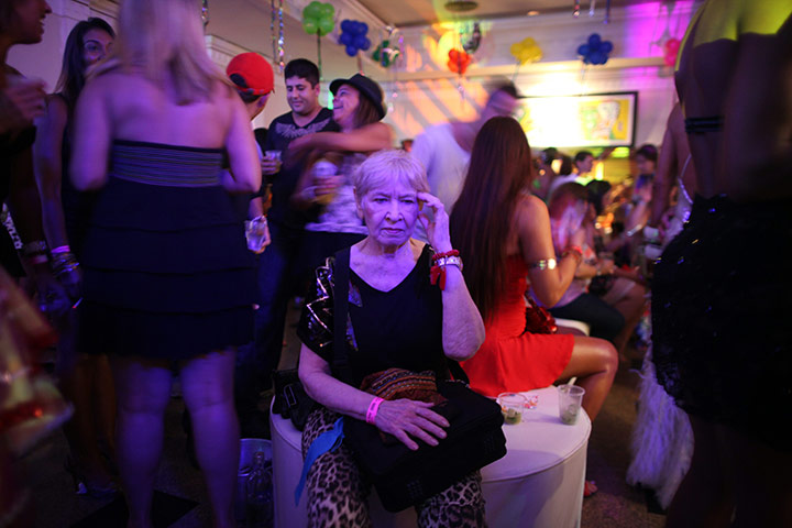 from the agencies : A woman takes a break at a gay Carnival celebration
