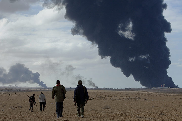 Sean Smith: 9 March: Rebels fighters walk to the front on the road towards Bin Jawad