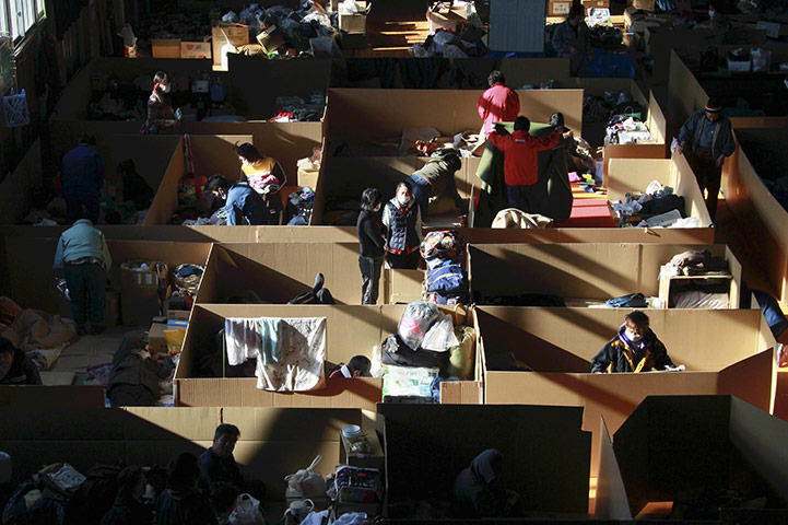 24 hours in pictures: Evacuees clean their quarters an evacuation centre, Japan