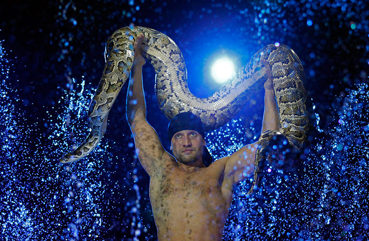 24 hours in pictures: A Russian circus artist performs with his snake at Budapest's Grand Circus
