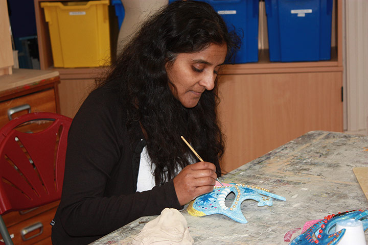 Exhibition for Society: A woman paints a mask for an exhibition by the visually impared