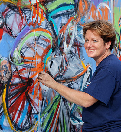 Exhibition for Society: A woman painting for an exhibition by the visually impared