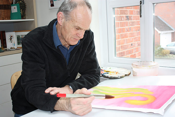 Exhibition for Society: A man painting for an exhibition by the visually impared