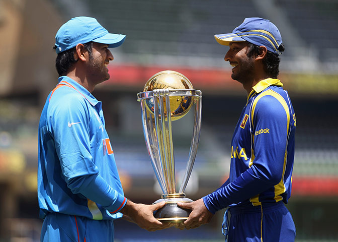 Cricket World Cup Crazy: MS Dhoni of India & Kumar Sangakkara of Sri Lanka pose with the World Cup 