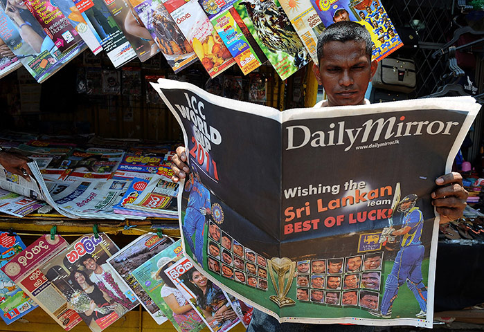 Cricket World Cup Crazy: A Sri Lankan man browses through a newspaper