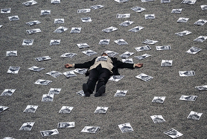 24 hours in pictures: A man lies on Sunflower Seeds installation by Ai Wewei at the Tate Modern