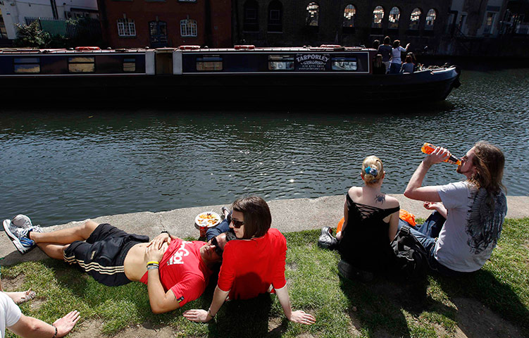 UK weather: People sit by canal at Camden Lock, London