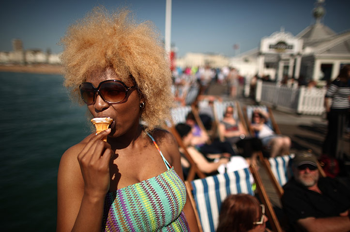 UK weather: A visitor enjoys an icecream on the pier in Brighton