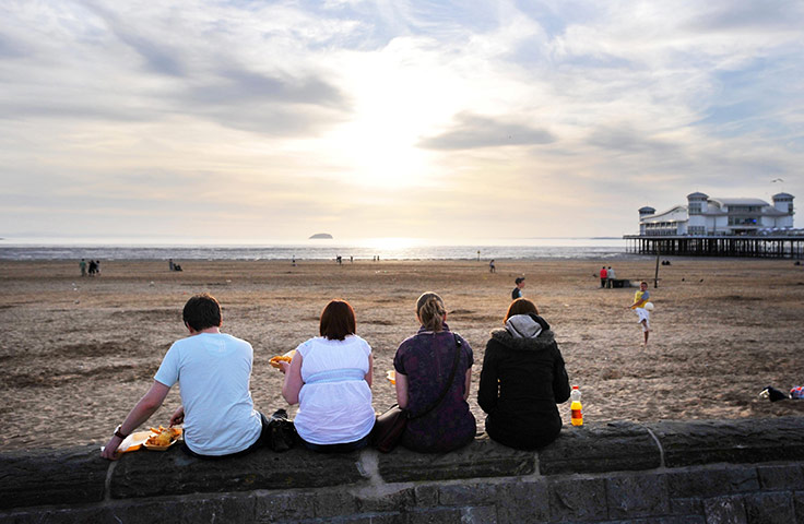 UK weather: People enjoy chips at sunset by the Grand Pier at Weston-Super-Mare
