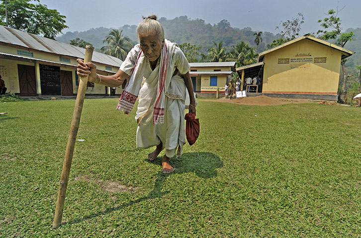24 hours: Assam, India: A woman comes out of the No 9 Budha Mayong polling station
