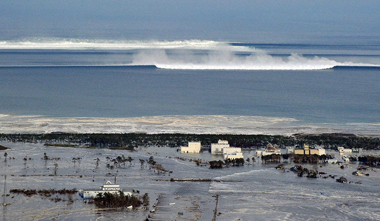 Japan disaster 1 month on: An oncoming tsunami strikes the coast in Natori City, Miyagi Prefecture