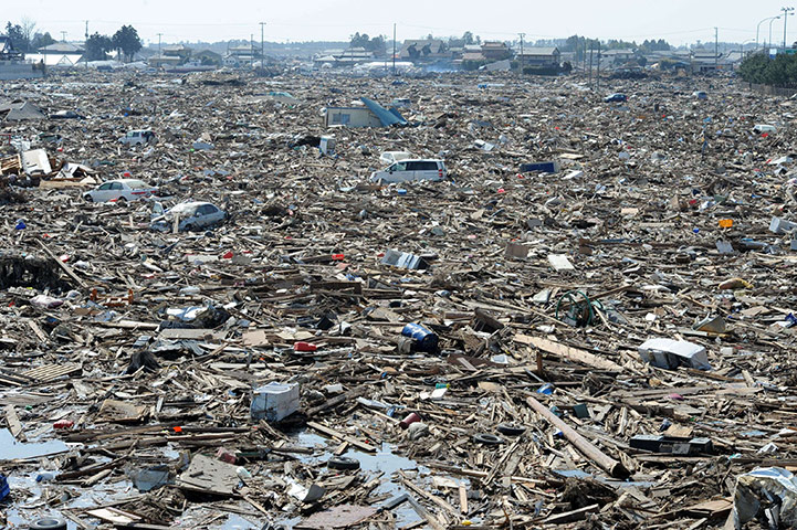 Japan disaster 1 month on: Debris lie strewn across a large area of NAtori
