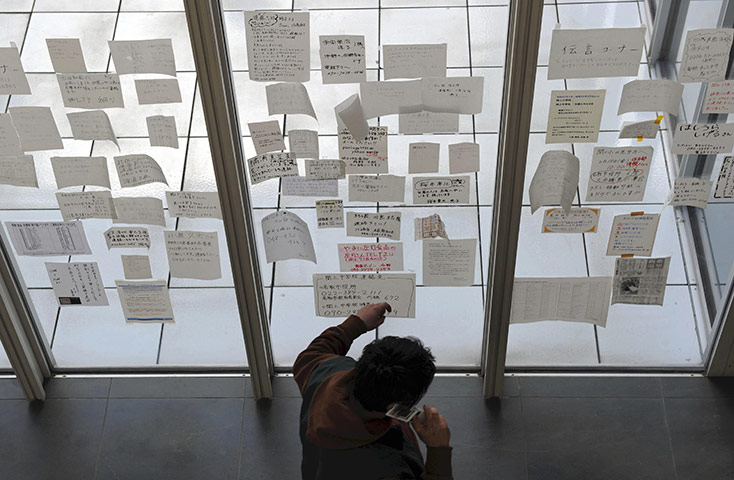 Japan disaster 1 month on:  notes at Natori City Hall, appealing for missing loved ones