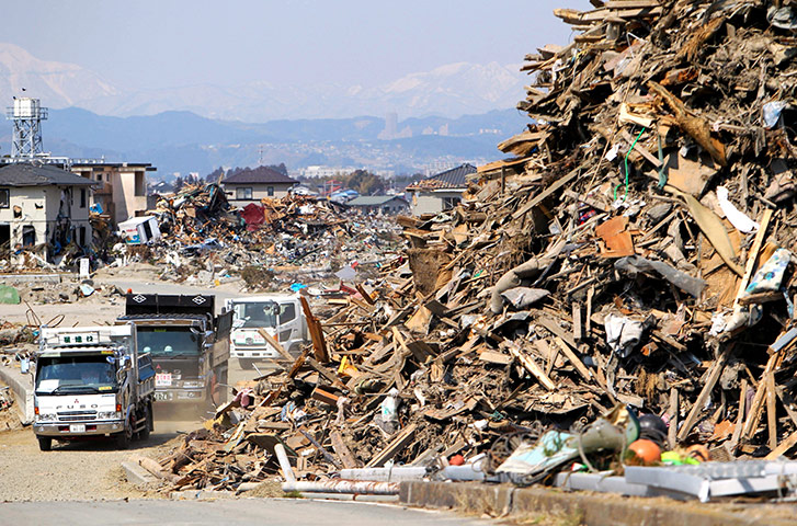 Japan disaster 1 month on: Trucks help to remove the debris left over from the disaster