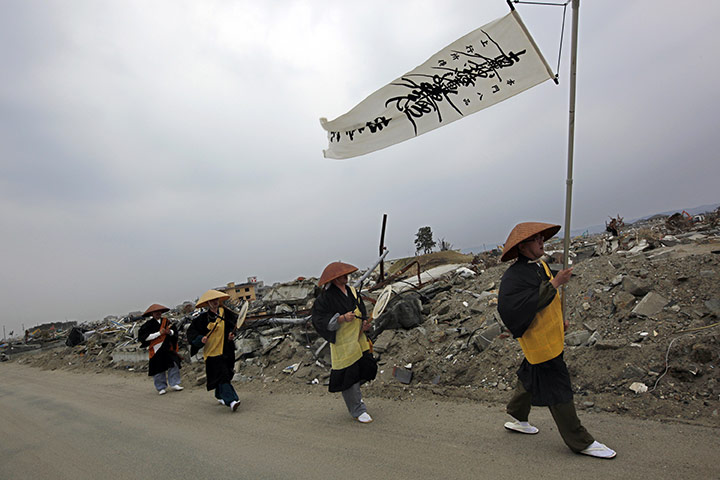 Japan disaster 1 month on: Buddhist monks pray in an area destroyed by the disaster