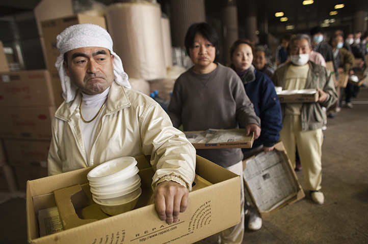 Fukushima disaster: 9 April:  Earthquake victims line up for food at evacuation shelter