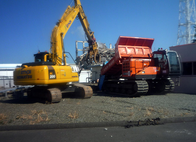Fukushima disaster: 6 April: A remote controlled unmanned crane loads rubble