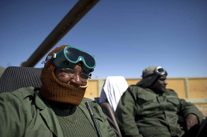 Ajdabiya, Libya : Two rebel soldiers sit in their vehicle near the western gate, Ajdabiya