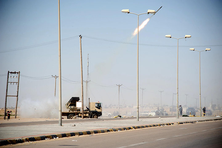 Ajdabiya, Libya : Rebel fighters launch rockets from the western gate, Ajdabiya
