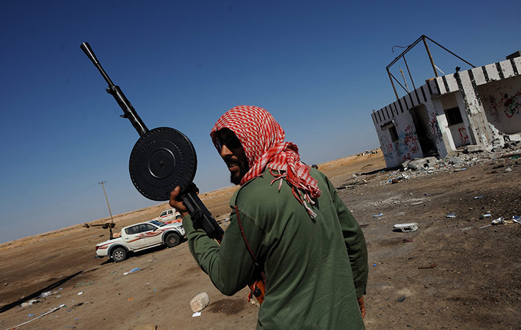 Ajdabiya, Libya : A Libyan rebel fighter holds a machine gun, Ajdabiya
