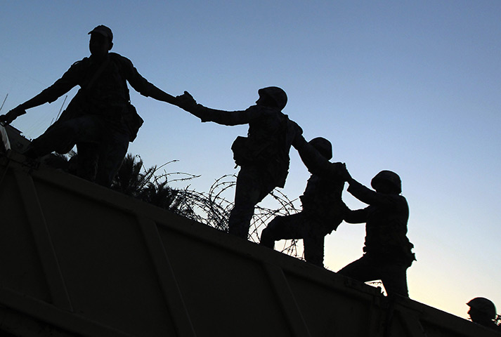 24 hours in pictures: Military personnel clear razor wire from Tahrir Square, CAiro