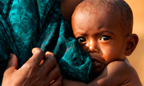 An Indian tribal woman feeds her child at a camp in Dharbaguda