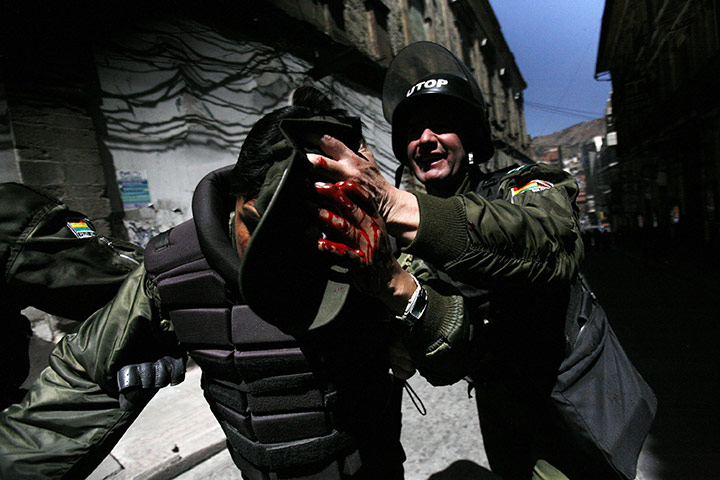 24 hours in pictures: An injured riot policeman in La Paz