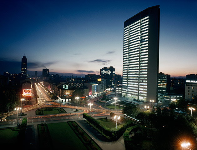 10 best: tall buildings: Downtown traffic zooms past the illuminated Pirelli building at night