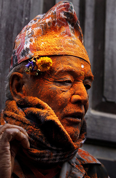 24 Hours in Pictures: An elderly Nepalese man has his face covered with vermilion powder