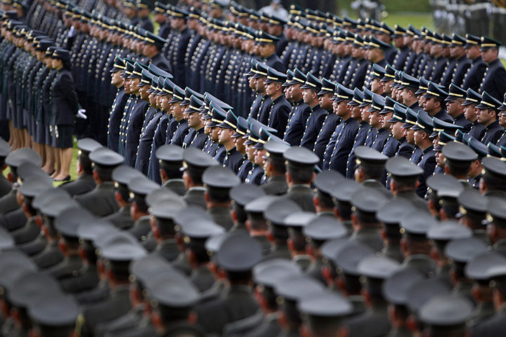 24 Hours in Pictures: Police officers stand in formation during a promotion ceremony in Colombia