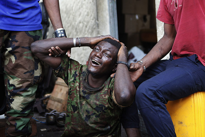 24 hours: Abidjan, Ivory Coast: A wounded prisoner weeps in pain at a military base