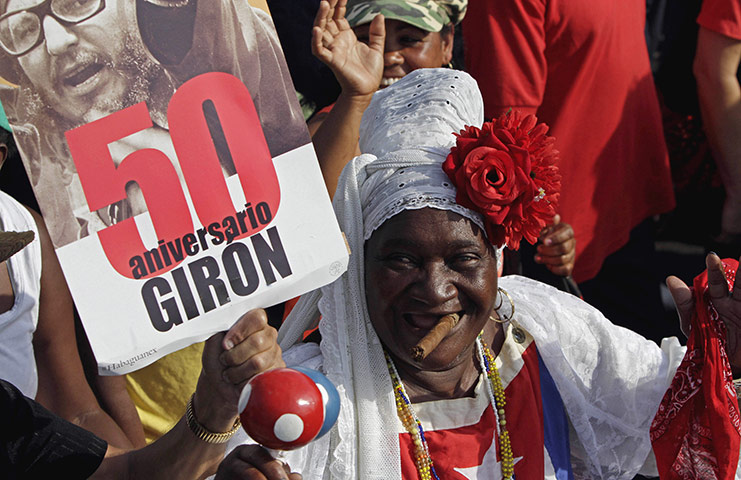 Bay of Pigs anniversary: A woman smokes a cigar while marching in the parade