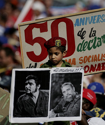 Bay of Pigs anniversary: A boy dressed as a Cuban soldier watches a parade 