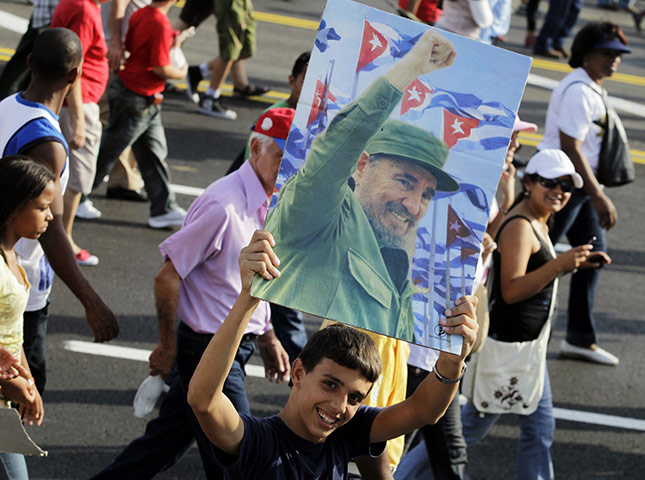 Bay of Pigs anniversary: A youth holds a picture of Cuban former president Fidel Castro