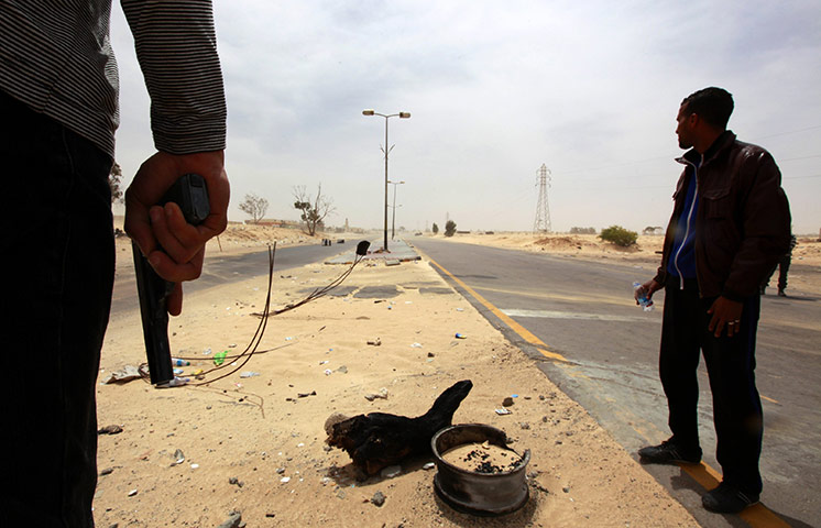 24 hours in pictures: Rebel fighters are seen at the eastern entrance of Ajdabiyahh
