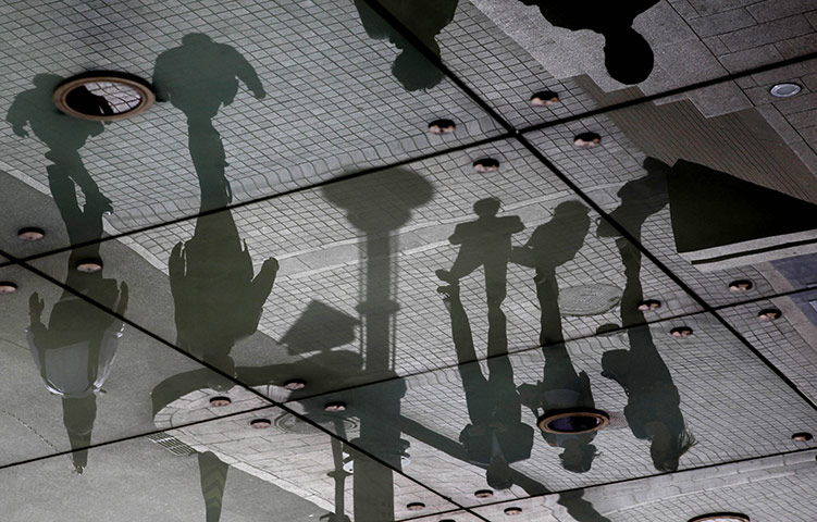 24 hours in pictures: Shadows and reflections of pedestrains in Beijing, China