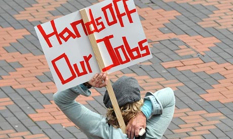 A protestor tucks a placard into her bag