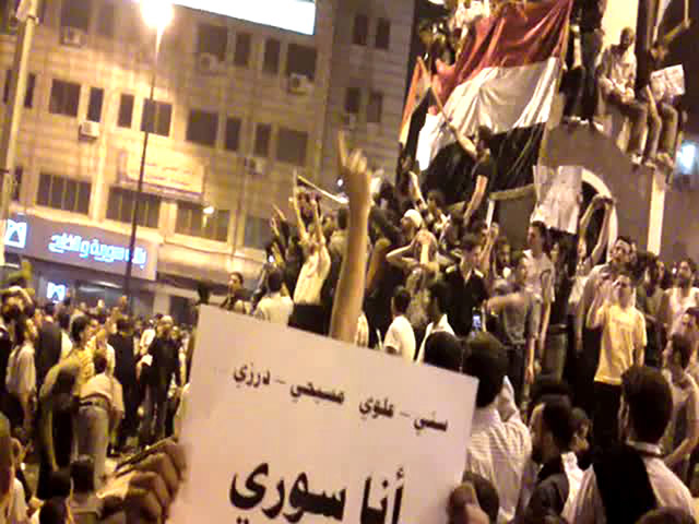 Syria protests: Syrian anti-regime protesters waving their national flag