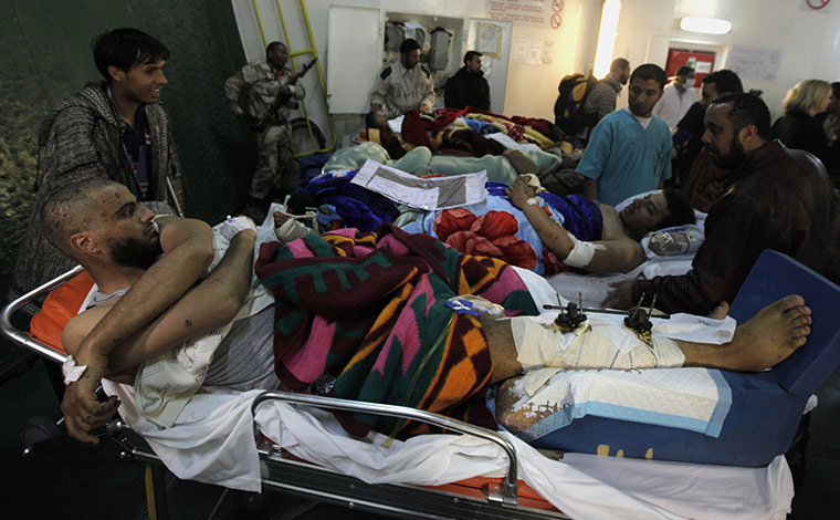  Misrata, Libya : Injured Libyan men are lined up to be moved toward waiting ambulances