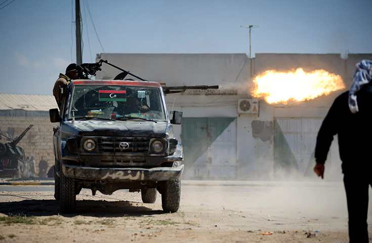 Misrata, Libya : Libyan rebels fire a heavy machine gun mounted 
